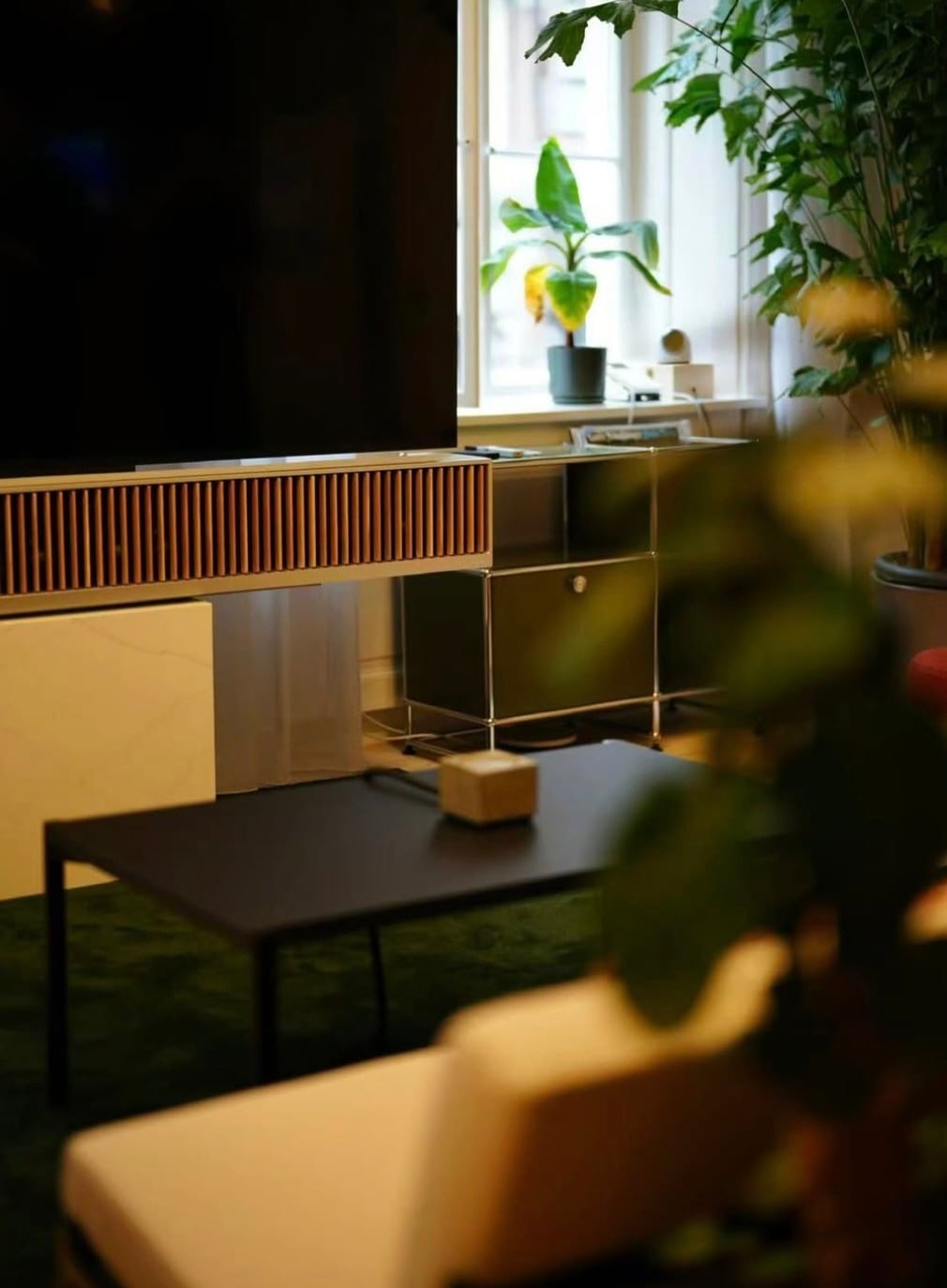 Soundbar and dial prototype beside a window with houseplants