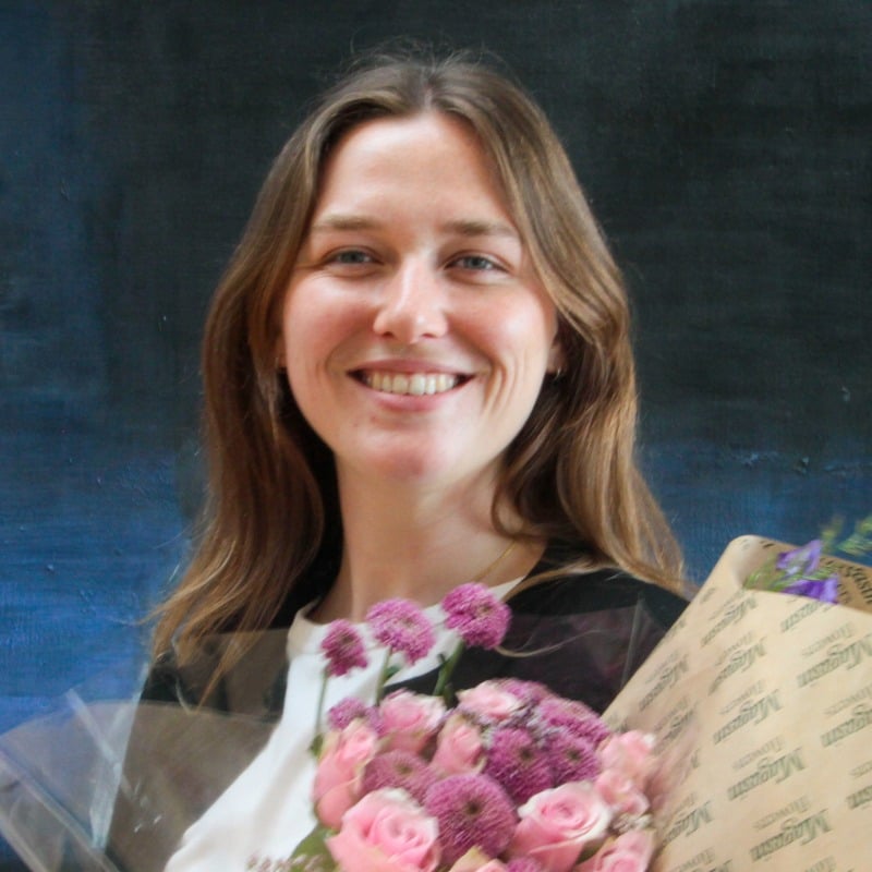 Kate Bosen holding a bouquet of pink flowers
